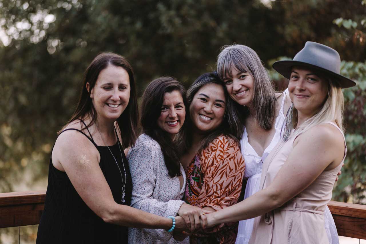 Group photo of women holding hands